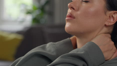 close up of anxious woman sitting indoors on sofa working from home using laptop worried about cost of living crisis 3