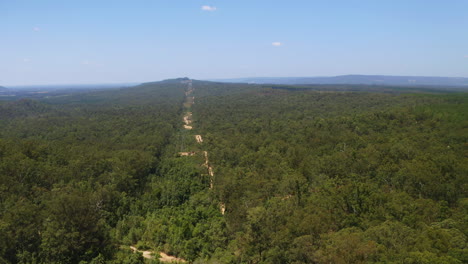 Aerial-Drone-4K-Flyover-Dirt-Road-Four-Wheel-Drive-Track-In-Glasshouse-Mountains-Forest,-Australia