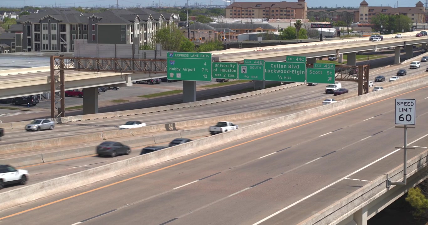 This establishing drone shot captures cars traveling on the I 45 South freeway just south of downtown Houston, Texas.