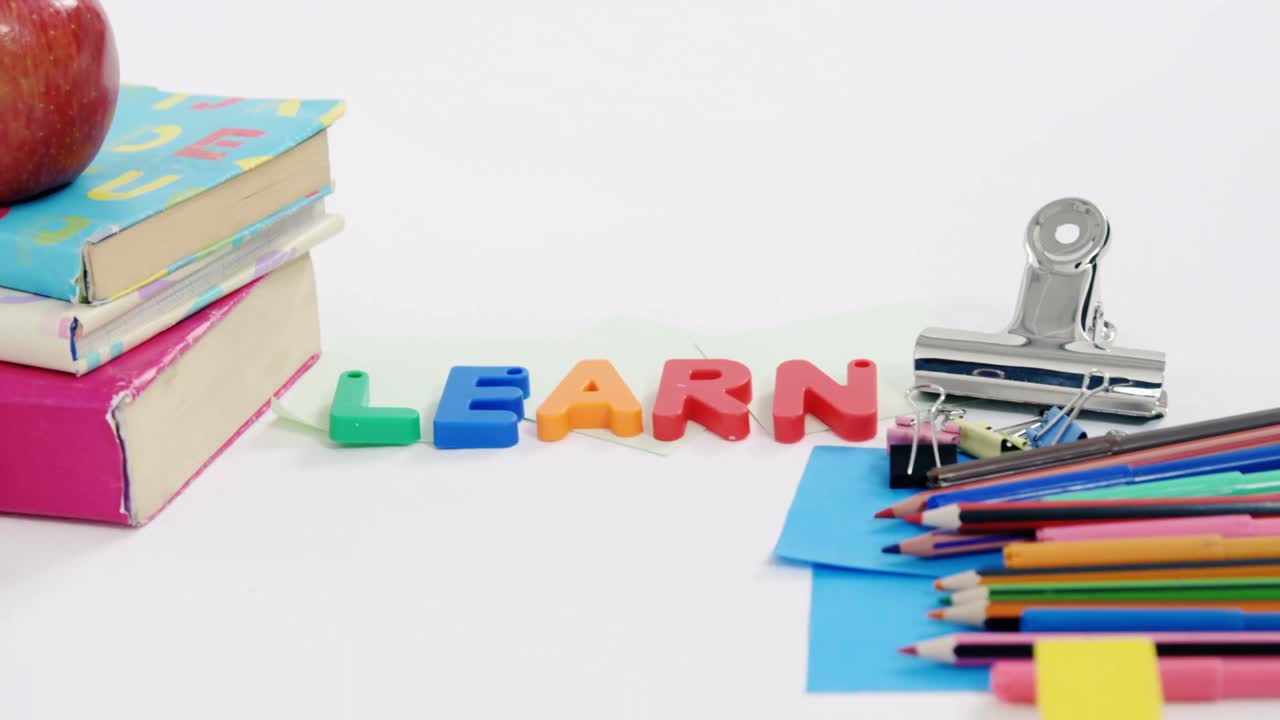 varios artículos de papelería y manzanas contra un fondo blanco