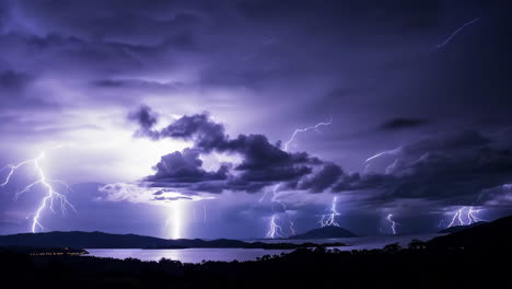 multiple lightning strikes over a dark lake landscape at night