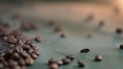 dolly left of hot coffee beans with smoke lying on the dark green background