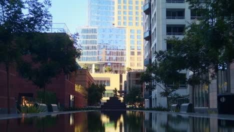 calm view modern cityscape with basin. high buildings on sunlight summer day.