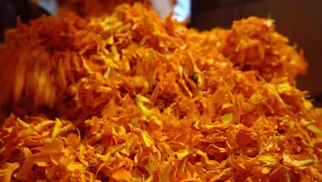 heap of marigold flower offerings in a temple in agra, india - closeup shot