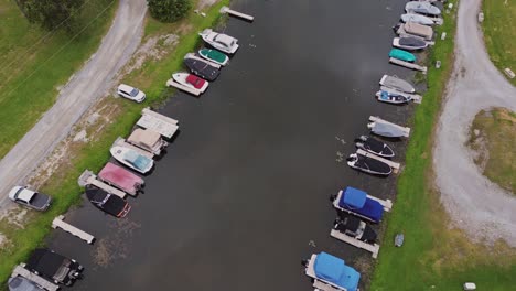 Boats-Moored-Along-Wooden-Jetties---aerial-drone-shot