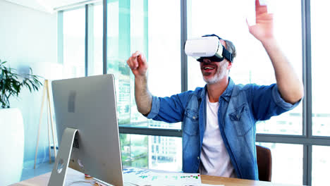 male executive using virtual reality headset at desk