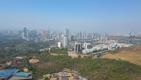 aerial drone shot capturing the expansive mumbai cityscape, showcasing a blend of towering skyscrapers, bustling streets, and the arabian sea in the background.