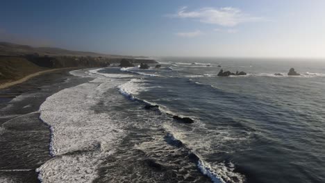 amazing aerial shot of rocks in the pacific ocean in a californian coast