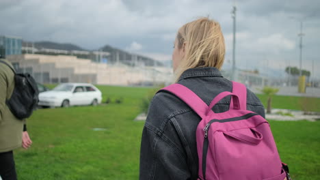 woman with a pink backpack at the airport