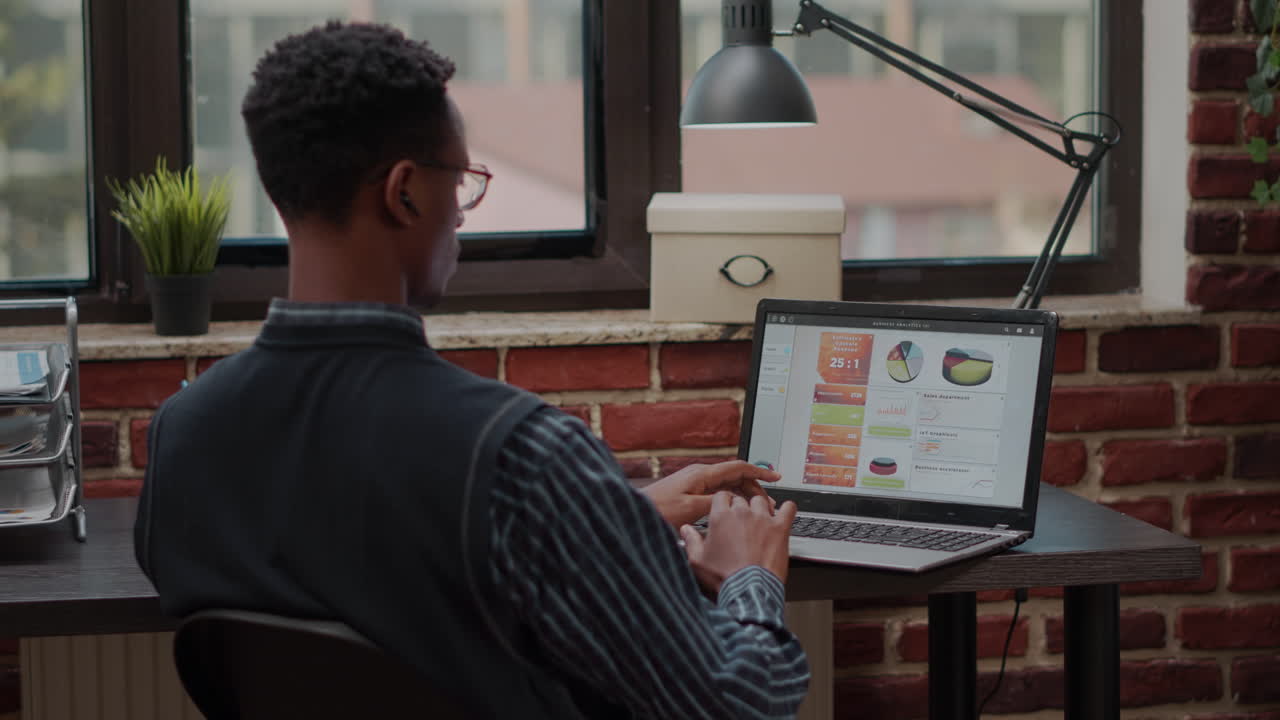Employee using laptop to plan career investment in startup office