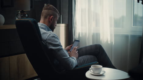 financial expert working on laptop, monitoring real-time stocks and exchange market charts, making investments. successful businessman works in comfortable office of investment bank. dolly shot.