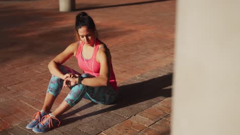 Woman-looking-at-her-watch-under-a-bridge