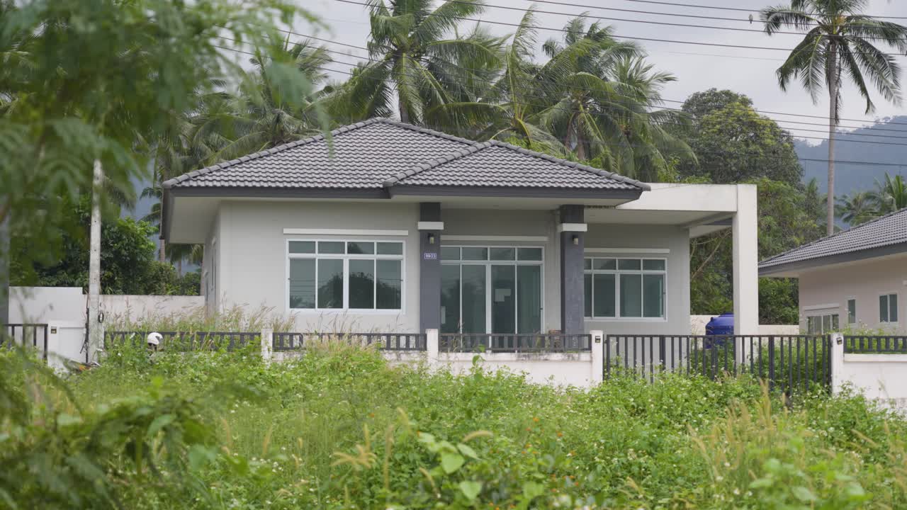 Static shot of a modern small house in the countryside of Koh Samui