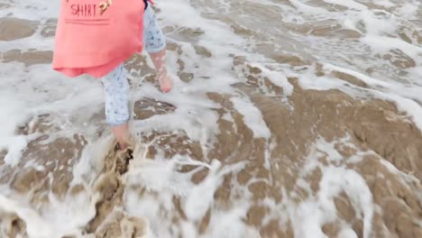 Young-girl-with-dark-hair-enjoying-Irish-sea-tide-on-the-coast