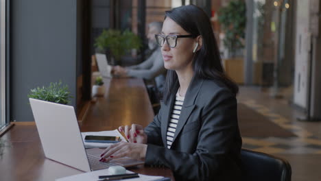 woman in video conference call in coffee shop