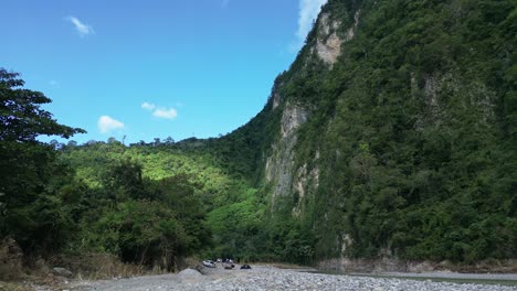 people with off-road vehicles 4x4 on shores of river, muchas aguas in dominican republic