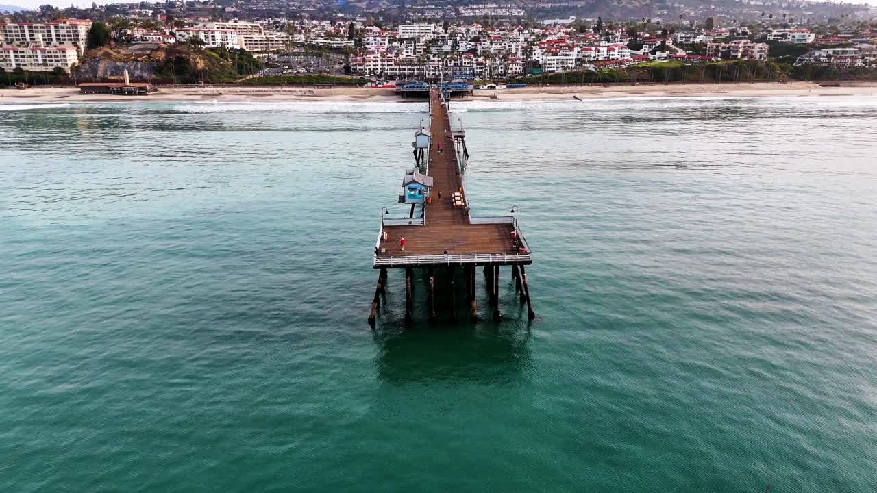 Aerial View of southern california pier with a beautful orange sunset