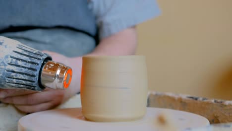 potter drying ceramic pot with special dryer