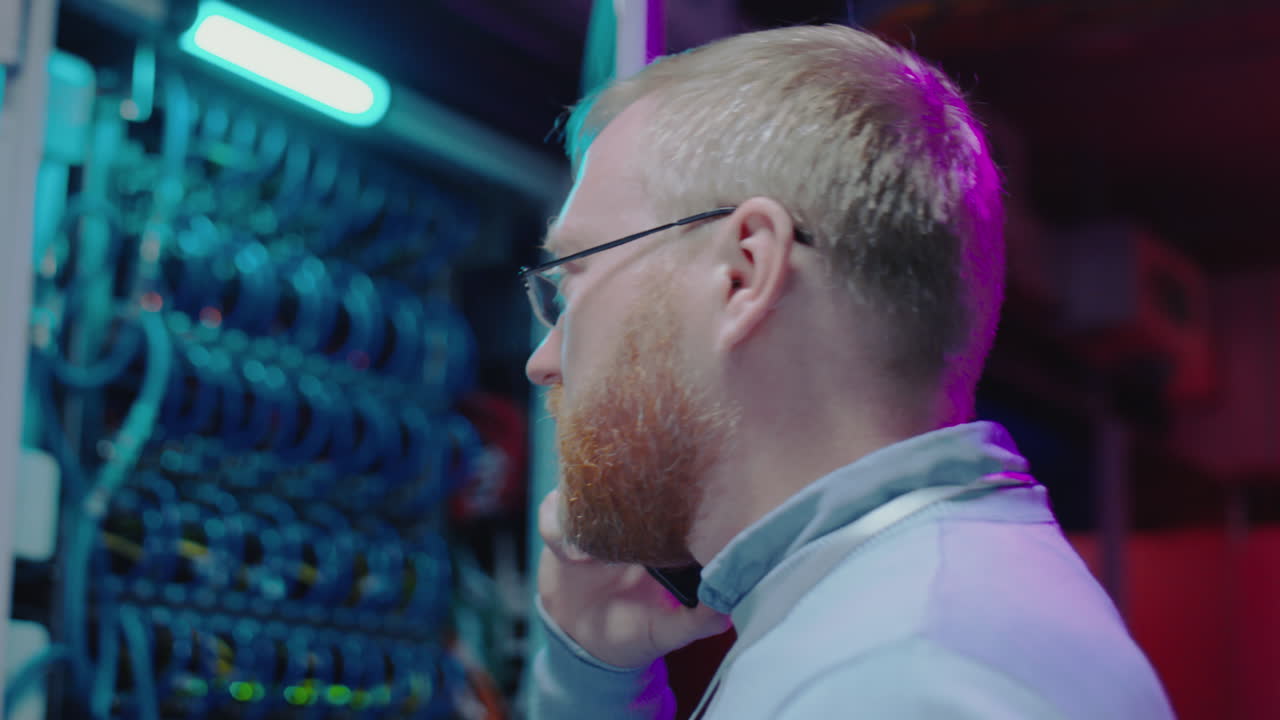 IT Professional on a Phone Call in a Server Room