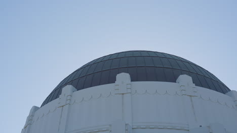 Toma-Panorámica-De-La-Cúpula-Del-Observatorio-Griffith-Con-Un-Helicóptero-Volando-En-El-Fondo-Ubicado-En-Las-Colinas-De-Hollywood-En-El-Sur-De-California