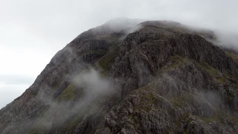 aerial drone footage of the mountain top in glencoe mountain range in the scottish highlands, taken in summer