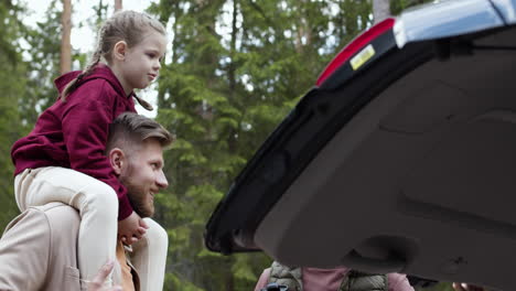 gay parents with kid outside the car