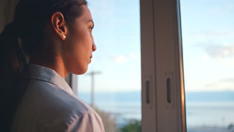 Woman-thinking,-hotel-window