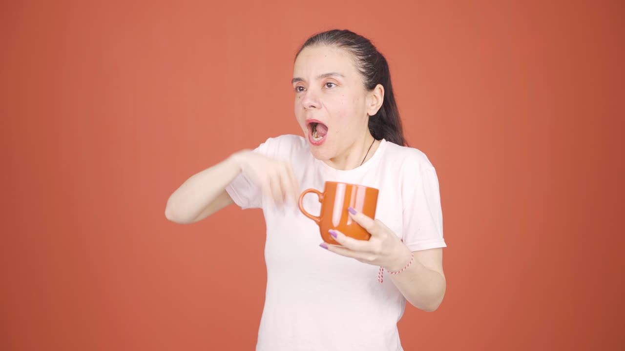 The woman's mouth is burning from the hot drink.