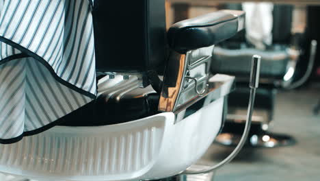 Barber-chair-rear-view.-Equipment-in-barbershop.-Armchair-in-beauty-saloon