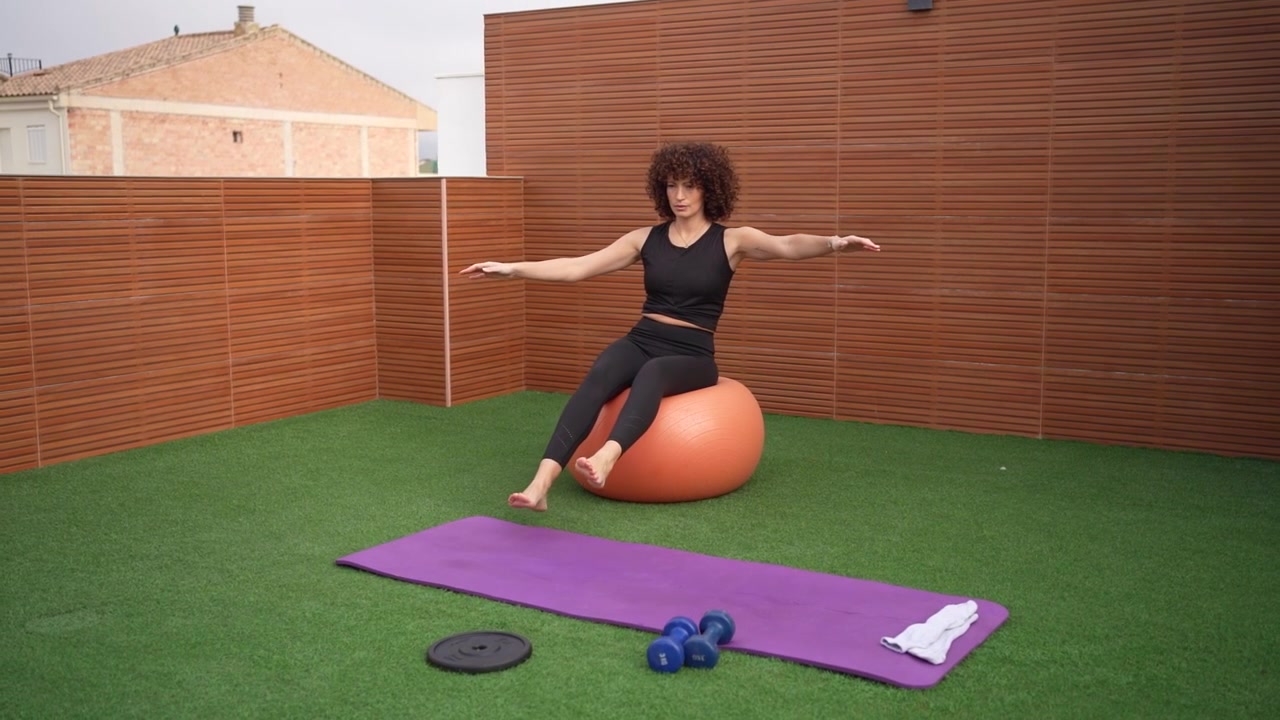 Outdoor fitness routine engaging in exercises on a balance ball while surrounded by nature
