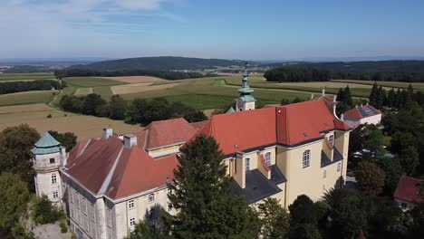 drone is flying over by a church tower from above