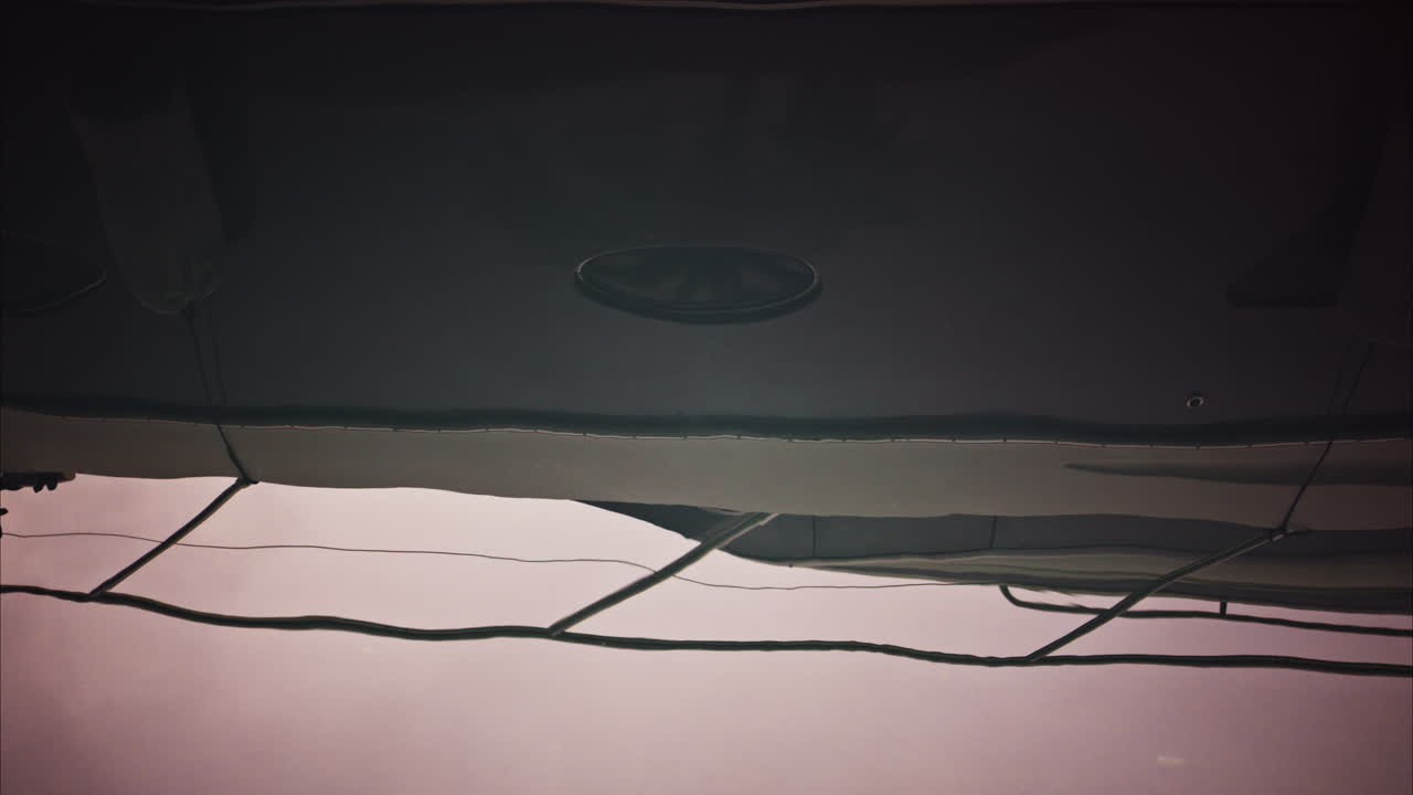 The water reflection of a boat docked in a harbour