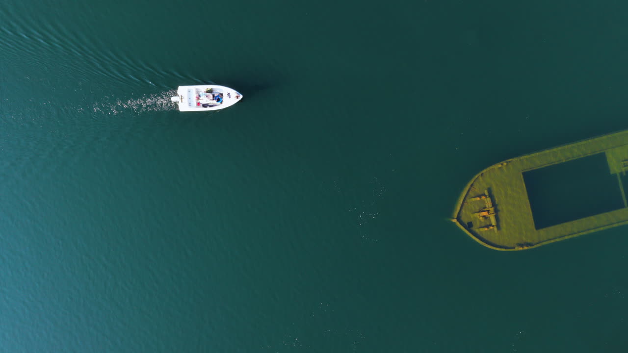 Birds eye aerial of a boat landing at the Itikkasalmi shipwreck in Finland