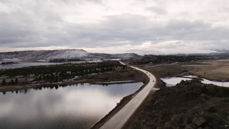 Drone-of-Lake-Granby-and-Grand-Lake-area-with-cars-traveling-on-the-road