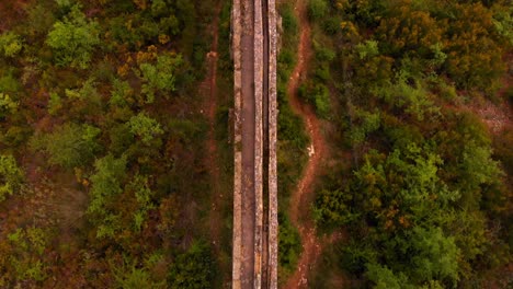 aerial top down view over waterway stone aqueduct tilt up at the end