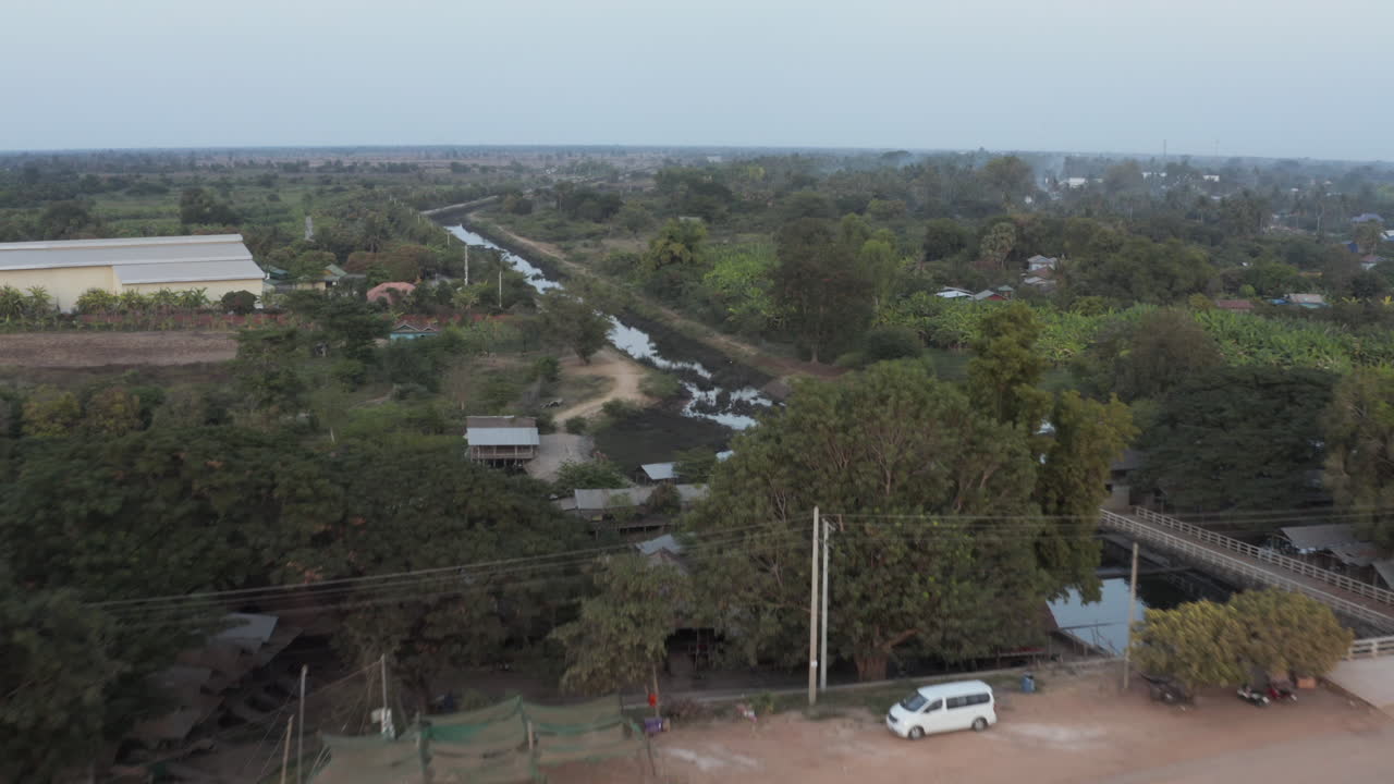 Flying over Camping Puoy reservoir barrage and reveal its irrigation system and rice fields