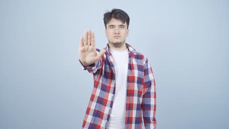 man making stop sign for camera.