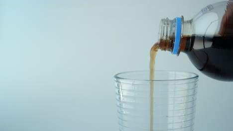 pouring soda into a glass