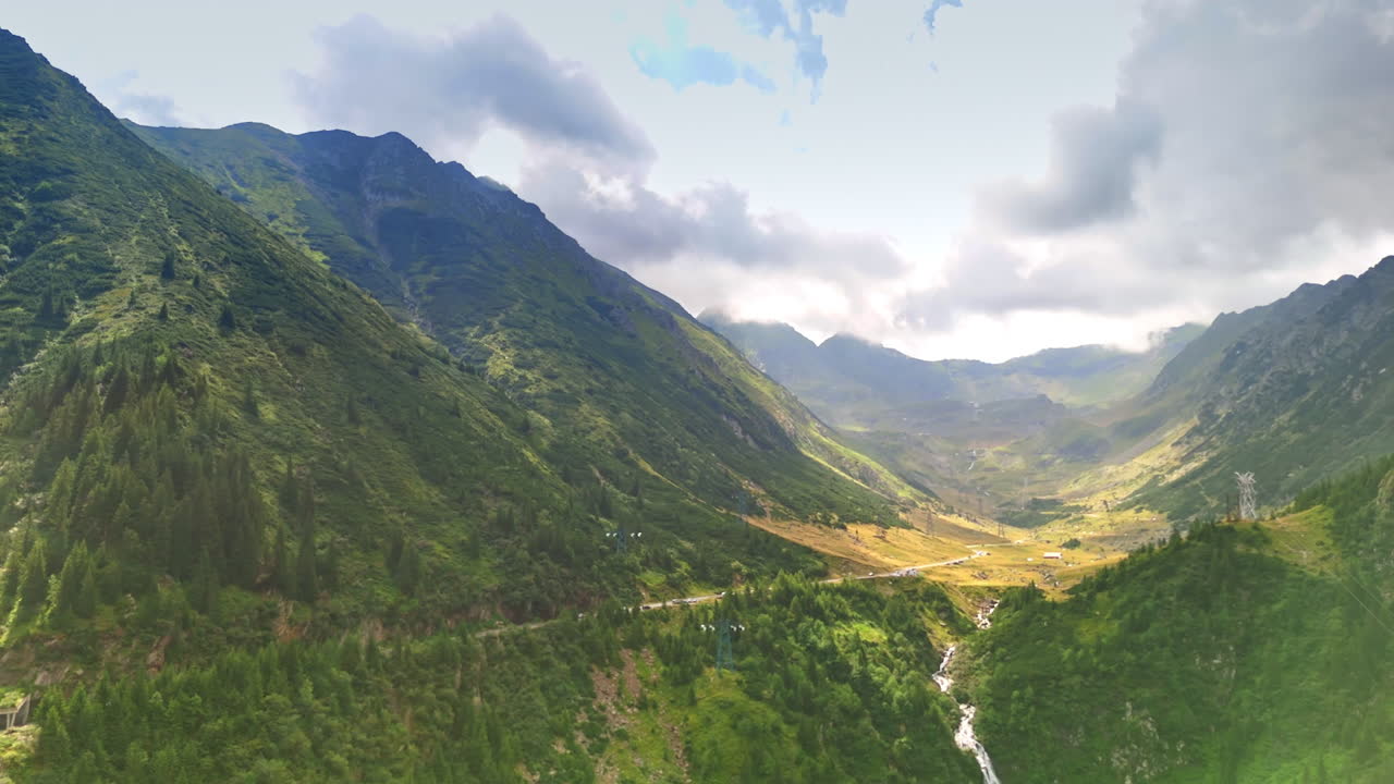 Mountain valley view of the Transfagarasan road in Romania. Green mountains and valley with the winding Transfagarasan road in Romania captured from above
