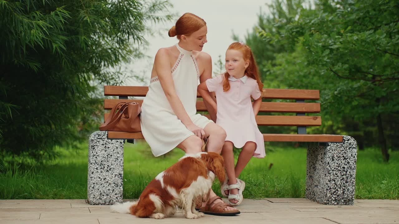 Mother and daughter with dog in the park