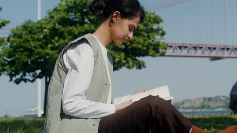 young woman reading in a park