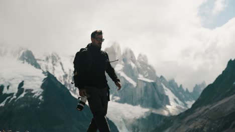 travel photographer walking on cerro torre mountain trail in santa cruz, argentina