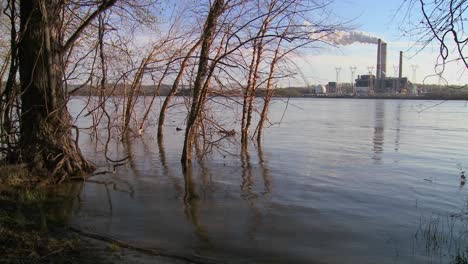 A-power-plant-with-smokestacks-near-a-river-1