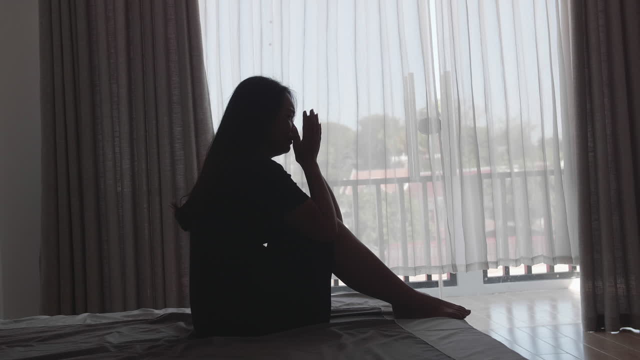 Young Woman Feeling Depressed And Stressed Sitting On The Bed