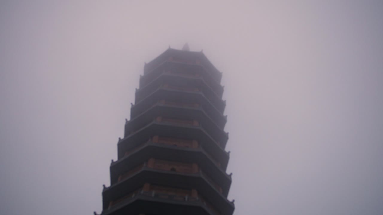 Top Exterior Facade Of Bai Dinh Pagoda In Ninh Binh Province Of Vietnam During Misty Morning. - Low Angle Shot