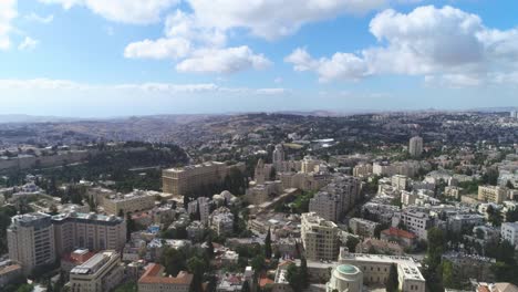 aerial fly over jerusalem with villages and settlements view. showing the wonder of co-existing living in cityscape with famous landmark against blue sky