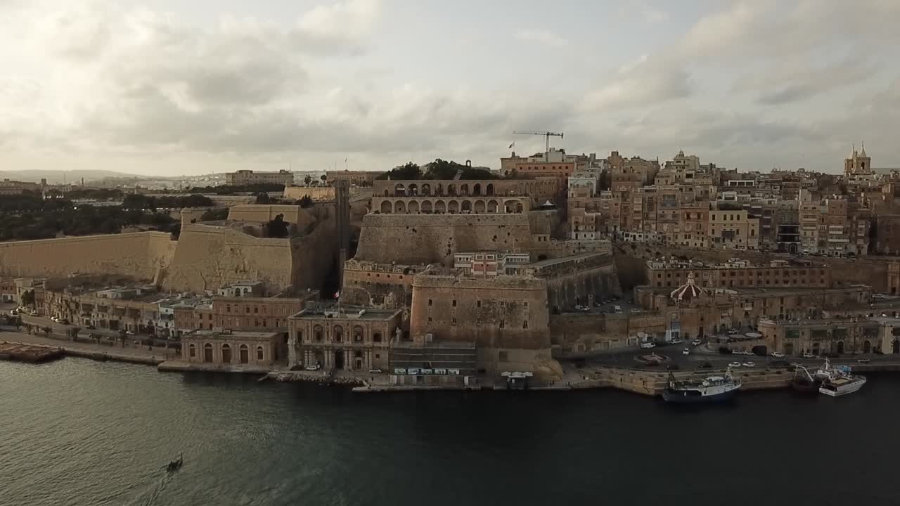Aerial view of the saluting battery and upper Barrakka gardens of Valetta, Malta, Europe. Dolly shot flying towards the saluting battery.