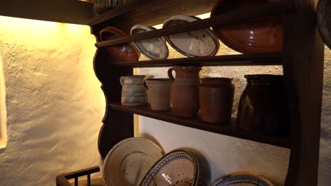 vintage pottery on rustic kitchen shelf in sandor petofi's mother's kitchen