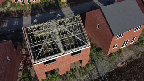 residential housing framework aerial view birdseye over unfinished rooftop development on urban building site real estate