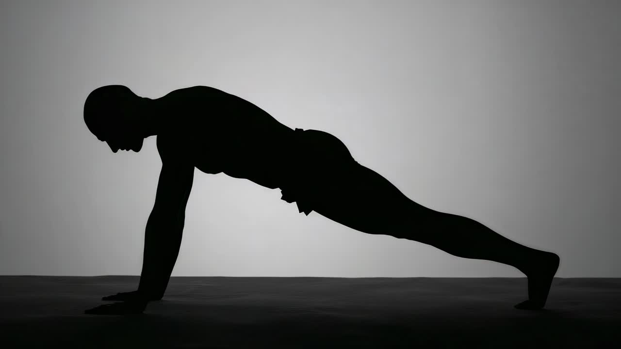 Routine starting, male figure doing push-up plank shifts in backlit studio wearing shorts for core